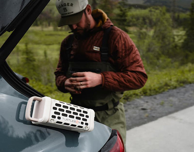 Person with speaker on a car with a natural outdoor background